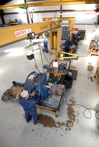 Overhead crane lifting transmission up for work