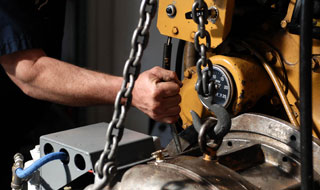 mechanic lifting transmission to repair